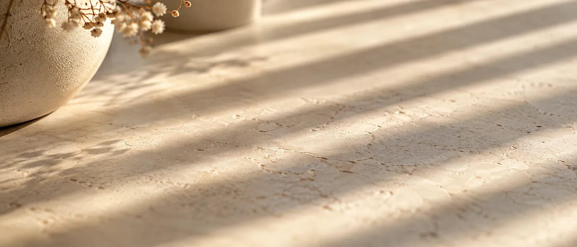 Soft bands of shade across a pale stone surface