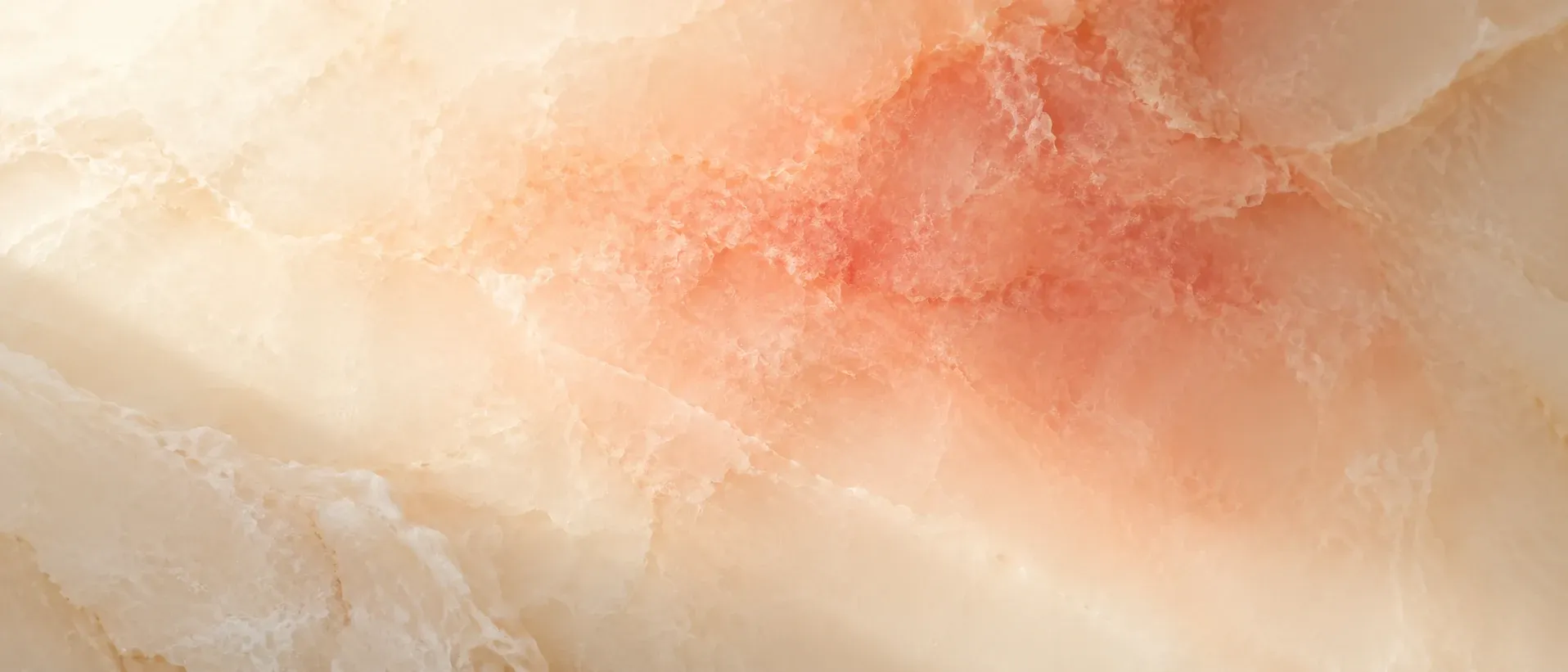 Warm flush of colour diffusing across a pale surface