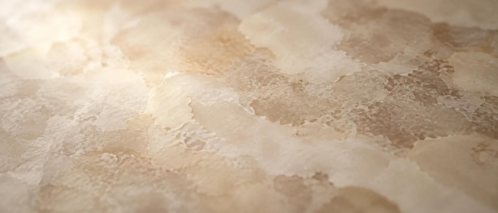 Soft overlapping patches of tone on a pale surface