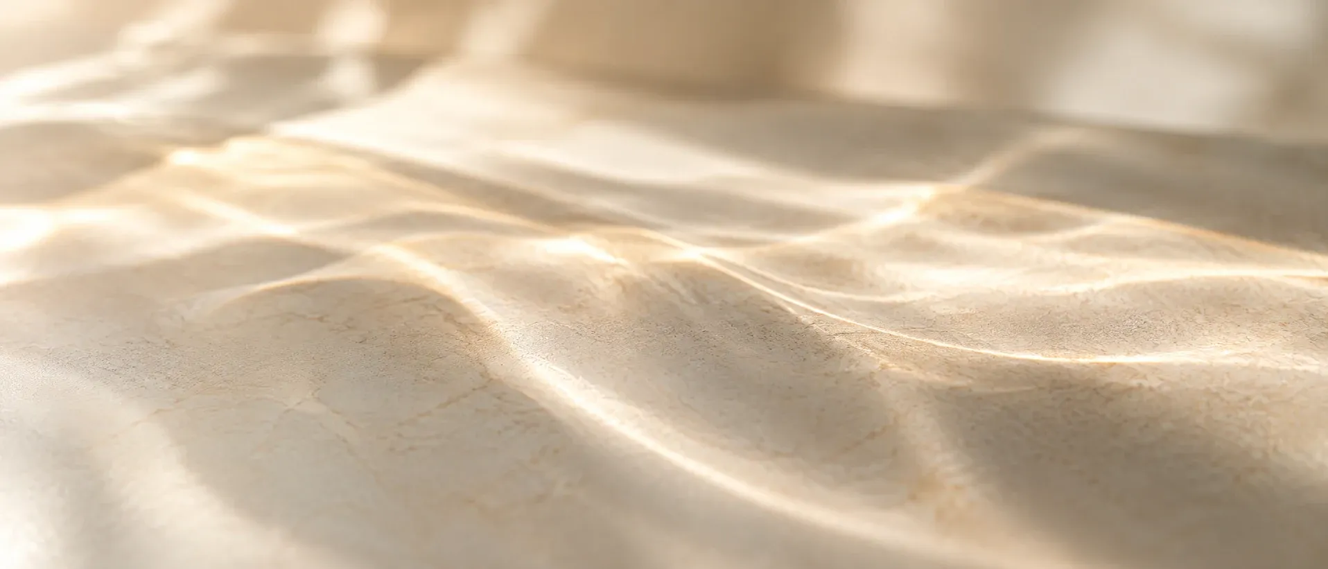 Soft overlapping waves of light on a pale surface